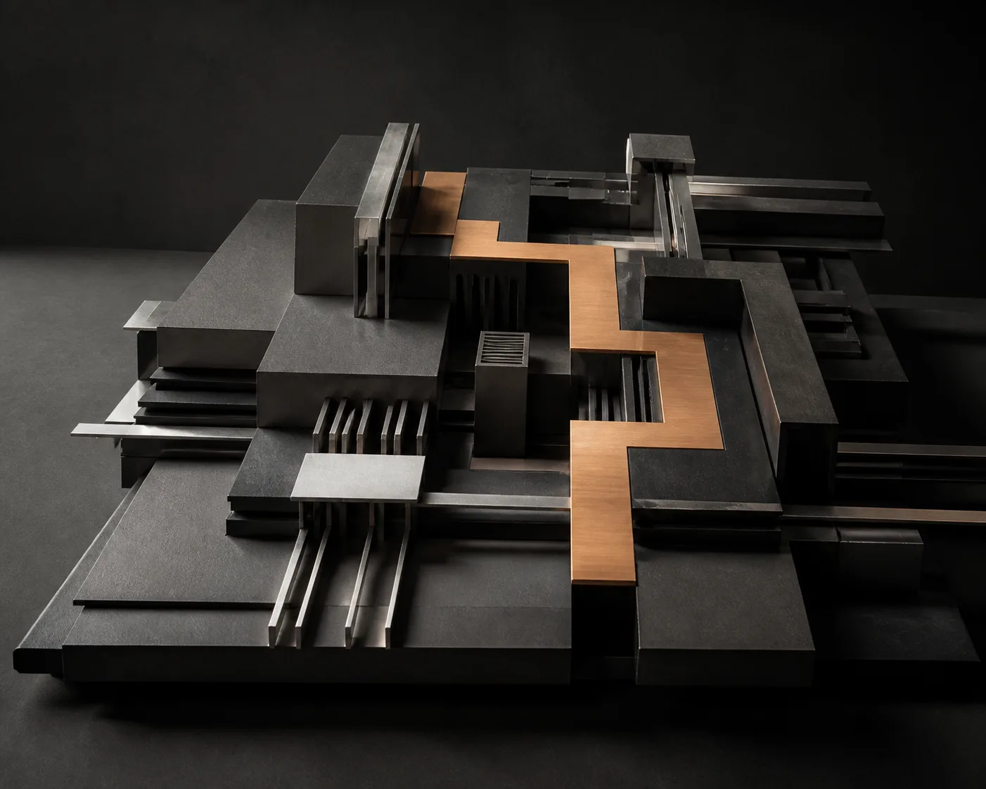 An engineered architectural model with an amber path connecting complex structures